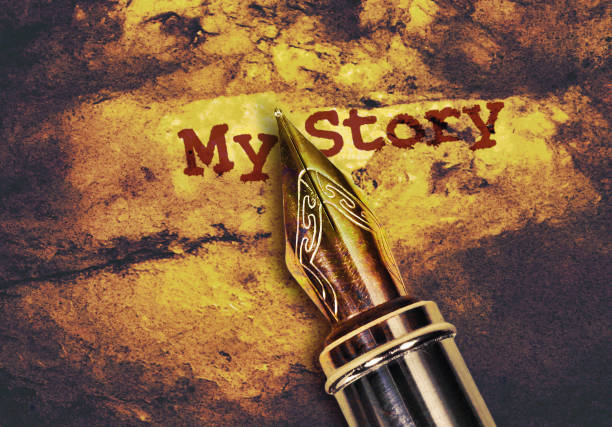 Closeup of a fountain pen and text My Story on golden background